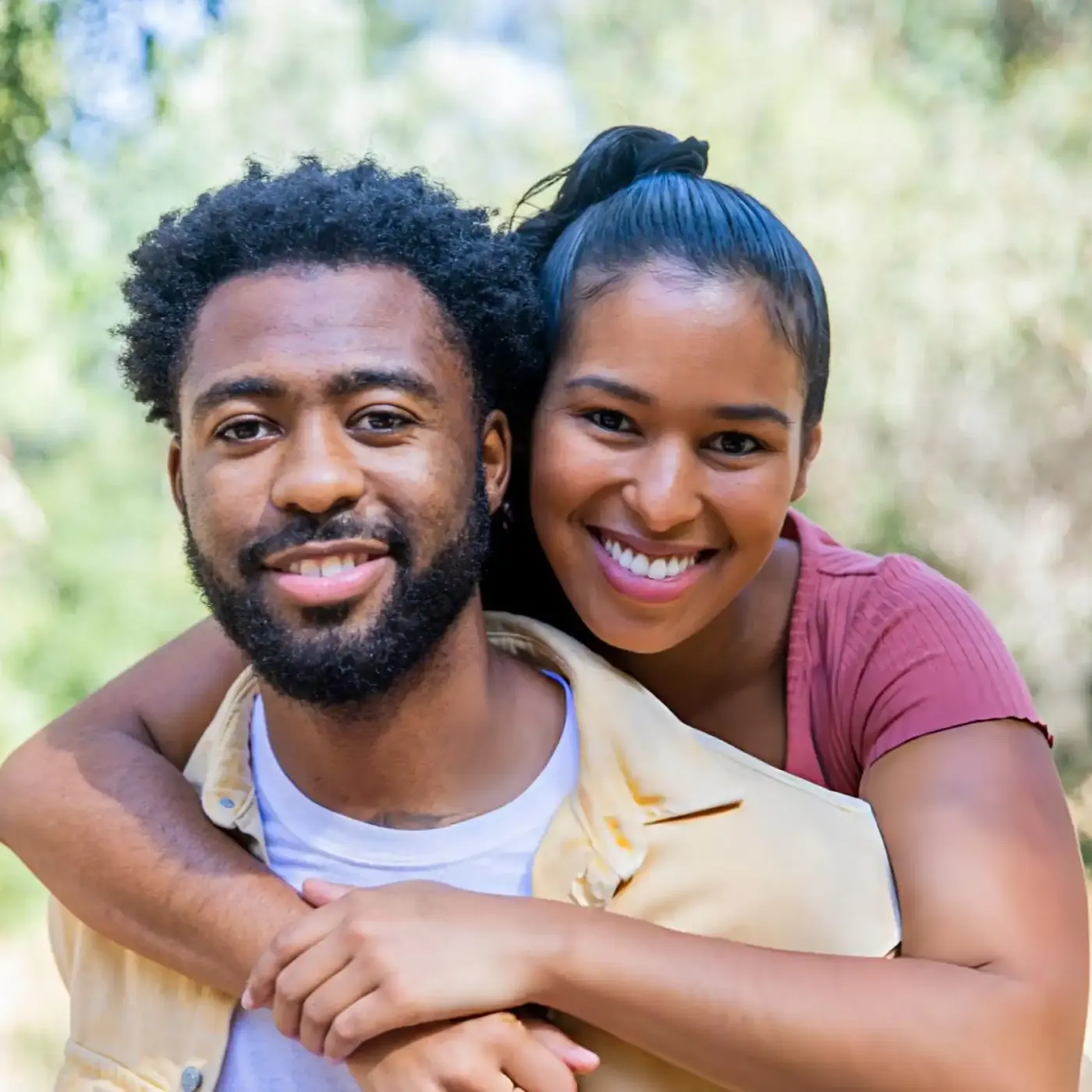 Chinelo and Marcus, smiling together outdoors